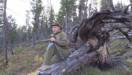 Vladimir Putin se odihnește pe un trunchi de copac, în Siberia