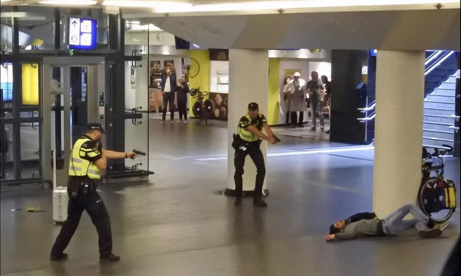 Atacatorul din Amsterdam Atacatorul afgan culcat la pământ după ce a fost împuşcat de poliţişti