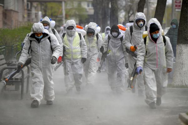 Angajati ai primariei sectorului 6 atomizeaza dezinfectant pe trotuar si in spatiile adiacente Bulevardului Iuliu Maniu din Bucuresti, in timpul unei campanii de dezinfectare pentru a stopa raspandirea COVID-19, marti, 31 martie 2020