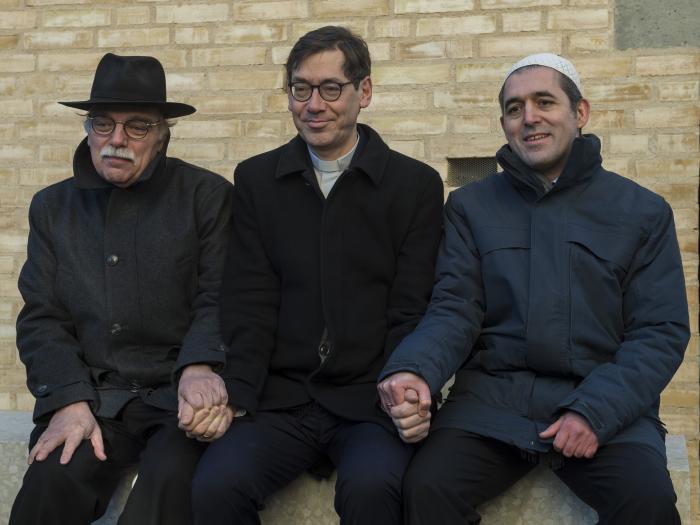 Rabinul Andreas Nachma (de la stânga la dreapta), pastorul Gregor Hohberg și imamul Osman Örs își dau mâinile la inaugurarea fațadei  „Casei Lui”
