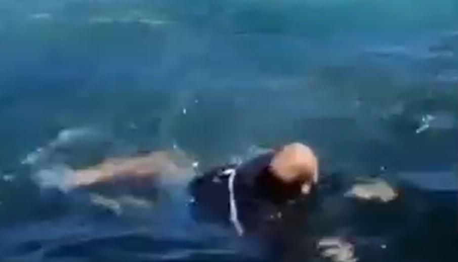 Momentul în care bărbatul încearcă să rămână la suprafața apei în timp ce balena înoată pe sub el