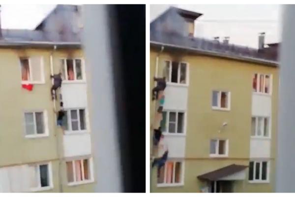 Gest impresionant: Copii scoşi dintr-un apartament în flăcări de vecinii care au făcut un lanţ uman, în Rusia