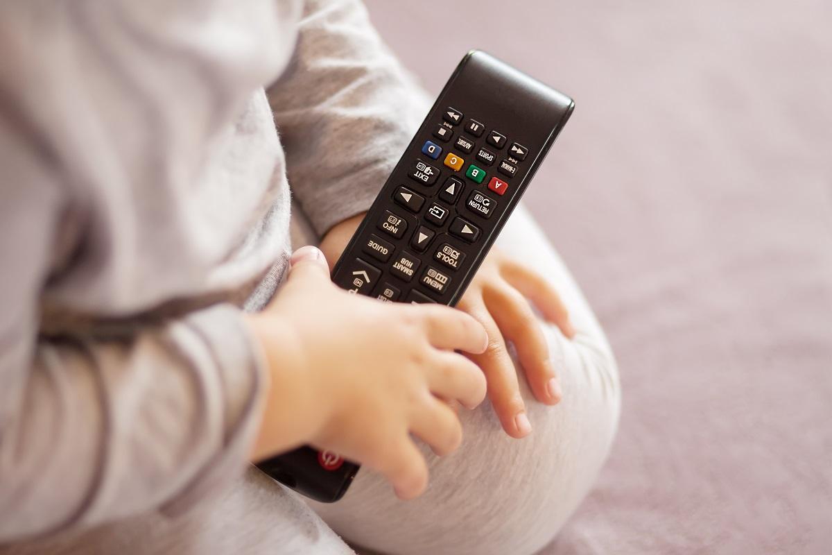 Telecomanda Copil cu telecomanda în mână