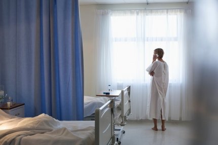 Femeie care vorbeşte la telefon într-o cameră de spital