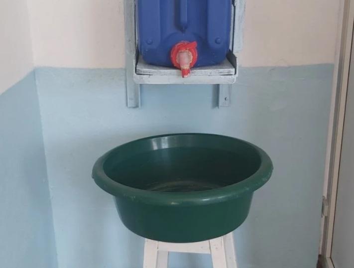 Un bidon şi un ligean pus pe un scaun, în loc de chiuvetă, într-o școală din Vrancea. Peste 250 de școli din țară nu pot asigura măsuri igienico-sanitare minime