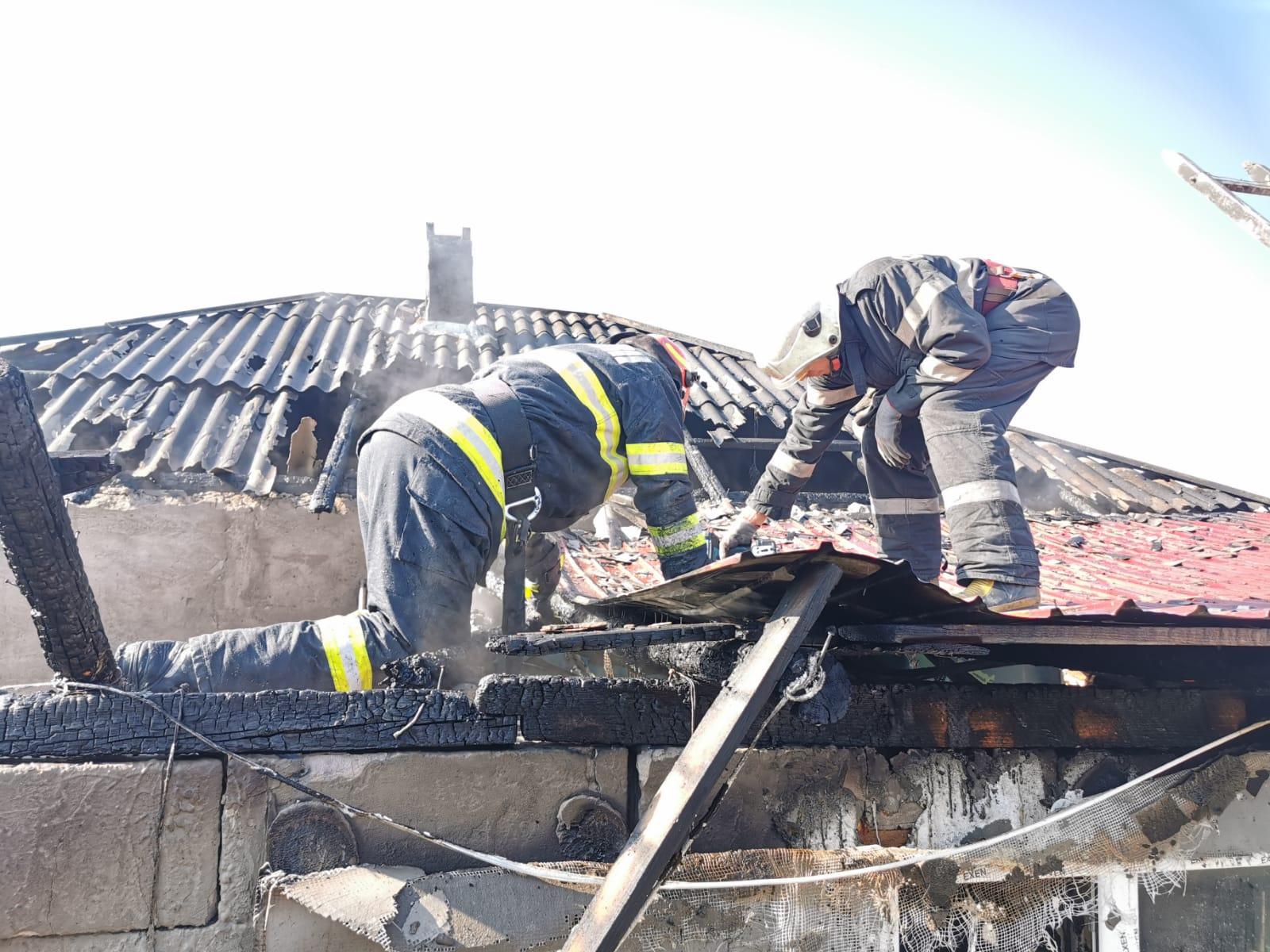 Pompierii ISU Botoșani intervin la stingerea incendiului care le-a cuprins casa celor doi frați din Roșiori