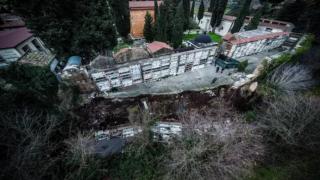 Zeci de sicrie au ajuns într-un pârâu, după ce o parte dintr-un cimitir din Italia s-a prăbușit