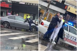 Poliţist de la Rutieră, filmat cum se urcă pe capota unui BMW şi scoate arma, în Capitală. Şoferul a fost luat cu forţa din maşină
