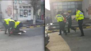 Patru poliţişti au pus la pâmânt şi au încătuşat un bărbat care a traversat strada printr-un loc nepermis (video)