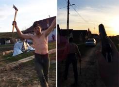Imagini halucinante cu un poliţist înarmat şi un scandalagiu cu toporul în mână: 'Împuşcă-mă şi te omor' (Video)