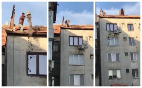 Treabă românească la Zalău. Muncitori pe jumătate dezbrăcaţi aruncă molozul de pe bloc (Video)