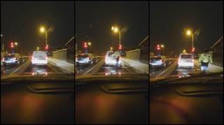 Un poliţist se dă jos la semafor şi îi curăţă luneta de zăpadă şoferului din faţa lui