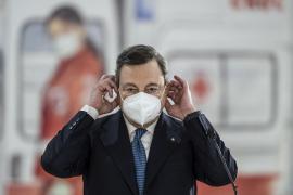 Primul ministru italian Mario Draghi își scoate masca de față în timp ce vizitează centrul de vaccinare Covid-19 de pe aeroportul Fiumicino