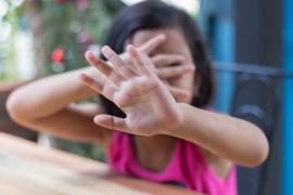 Copil care se ascunde cu mâinile