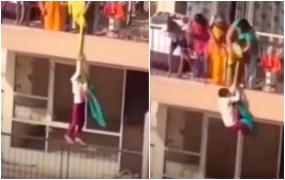 Momentul de infarct în care o indiancă își atârnă fiul folosind o haină pe post de frânghie, ca să-și recupereze rufele căzute la vecini