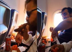 Doi români s-au filmat mâncând cârnaţi într-un avion: 
