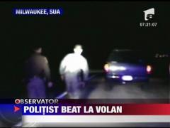 Politist beat la volan