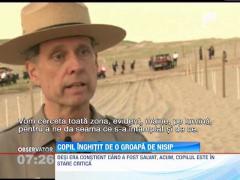 Copil inghitit de o groapa de nisip