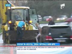 Potop în vestul ţării: spitale şi maşini sub ape