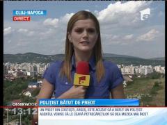Poliţist bătut de preot