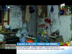 O mamă și un copil trăiesc sub pământ, lângă un cimitir!