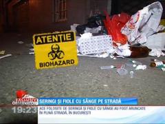 Seringi și fiole cu sânge pe stradă