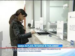 Iohannis trimite spre reexaminare legea privind darea în plată