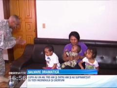 Imagini dramatice! O mamă şi cei trei copii ai ei au fost salvaţi de câţiva militari americani, după ce s-au aruncat de la etajul unui imobil cuprins de flăcări