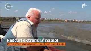 Pescuit extrem la Piteşti: Oamenii s-au grăbit să prindă cu mâinile goale peştii captivi în mâlul lacului de acumulare