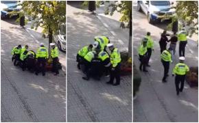 Un tânăr strigă disperat după ajutor, în timp ce șapte polițiști încearcă să-l încătușeze, pe o stradă din Râmnicu Vâlcea. Video