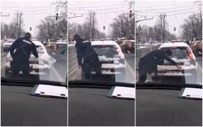 Un jandarm i-a curăţat luneta de zăpadă unui şofer din Iaşi, la semafor