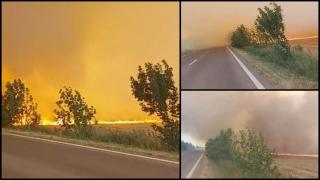 Şofer de TIR, filmat cum trece la limită pe un drum cuprins de flăcări şi fum. "Ăsta e iadul, măi"