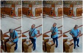 Momentul în care un bărbat fură bani din cutia milei cu un umeraş de sârmă. Ca să nu dea de bănuit, din când în când, se opreşte şi se închină