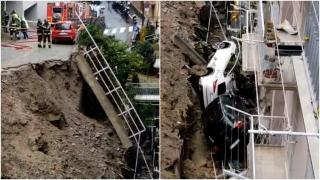 La un pas de tragedie, după ce zidul de susţinere a unei parcări s-a prăbuşit şi a luat-o la vale către blocuri, în Italia. Două mașini, înghițite de pământ
