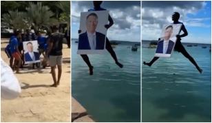 Iohannis, "botezat" în Tanzania. Momentul în care un localnic se aruncă în apă cu tabloul preşedintelui
