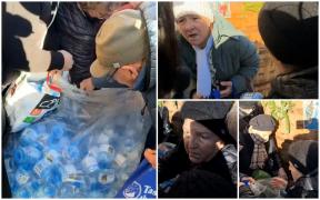 Lupte dure pentru a prinde Agheasma Mare, la Constanţa. O femeie a venit pregătită cu valiza pentru a căra cât mai multe sticle