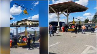 Momentul în care un elicopter aterizează într-o benzinărie din Curtea de Argeş. Pilotul a făcut plinul "bolidului zburător" şi şi-a văzut de drum