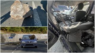 ANIMAŢIE. Maşină, strivită în mers de un bolovan desprins de pe versant. Şoferul a leşinat şi a intrat pe contrasens