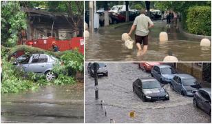 Imaginile dezastrului după furtuna din Capitală. Străzi şi scări de bloc inundate, copaci doborâţi de vânt