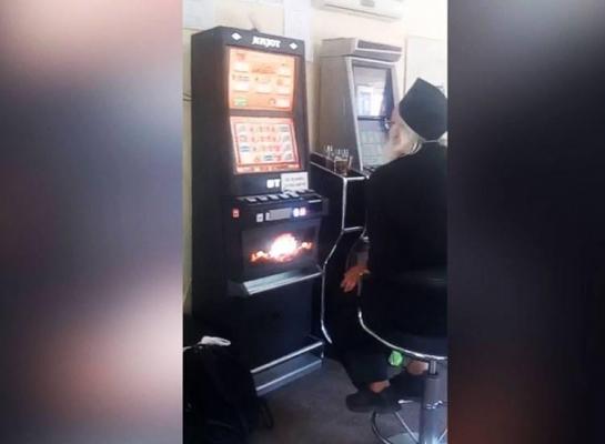 Călugăr filmat în timp ce joacă la păcănele şi bea bere într-un bar