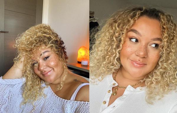 Grace Victory zâmbind, având părul creţ, blond şi purtând o bluză albă