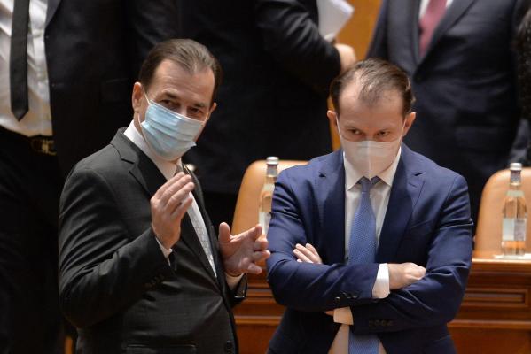 Ludovic Orban îi explică ceva lui Florin Cîţu, în Parlamentul României
