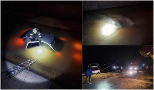 Un tânăr a plonjat cu mașina într-un canal cu apă, în Suceava. Polițiștii l-au ajutat pe șofer să ajungă pe malul betonat