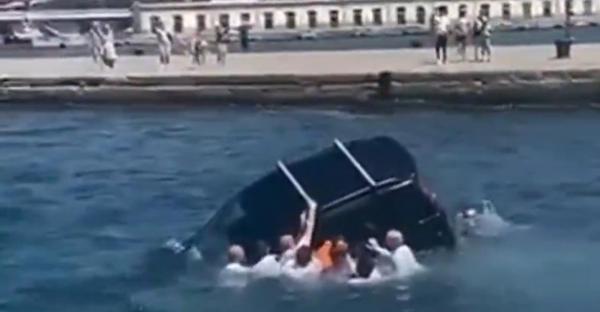 Momentul în care  mai mulţi militari salvează un şofer înainte ca maşina să dispară sub apă, la Trieste