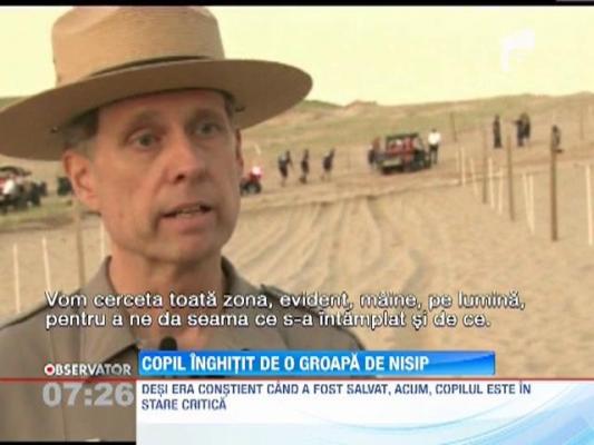 Copil inghitit de o groapa de nisip
