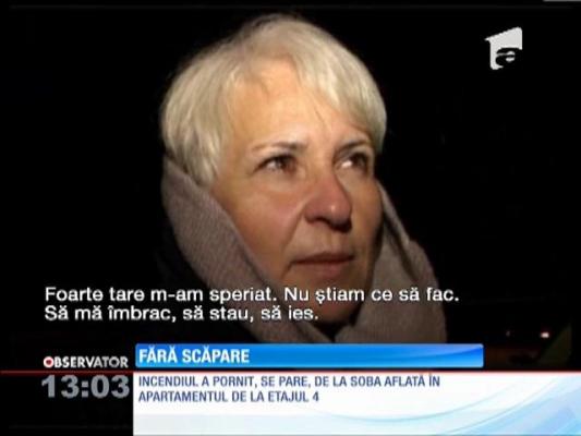 O femeie prinsă în incendiu s-a aruncat de la mansarda blocului
