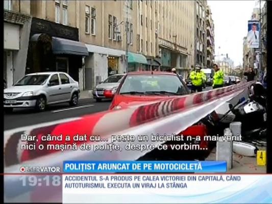 Polițist aruncat de pe motocicletă