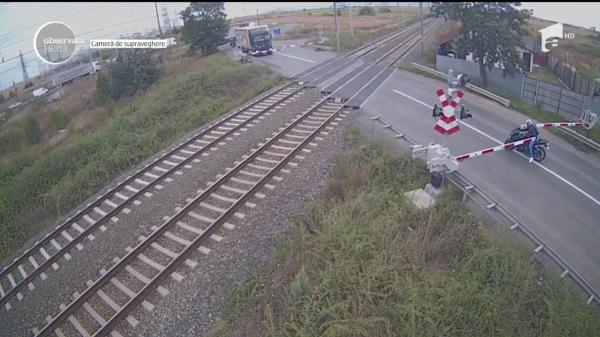 Imagini uluitoare la Arad: un motociclist nervos trece sfidător calea ferată, chiar la apariţia trenului