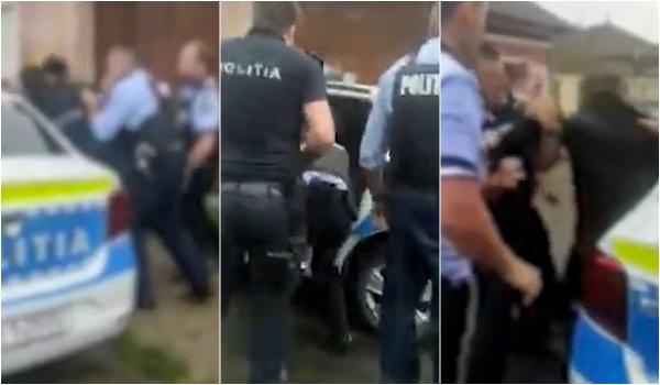 Patru poliţişti s-au chinuit să bage un bărbat beat în maşină, iar el a ieşit pe partea cealaltă. Totul, în huiduielile localnicilor