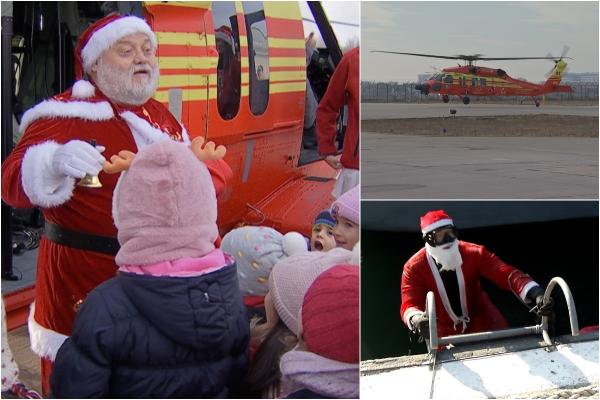 Moş Crăciun a renunţat la sanie şi a adus daruri copiilor cadrelor MAI cu noul Black Hawk. A mers apoi înot până în Constanţa